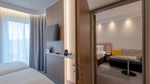 a hotel room with a bed and a desk at Holiday Inn Express - MUNICH NORTH by IHG in Munich