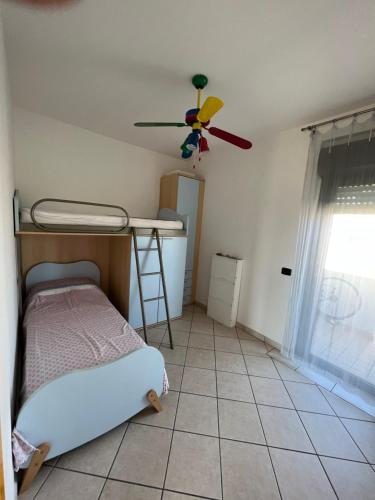 a bedroom with a bed and a ceiling fan at Bellavista in San Salvo