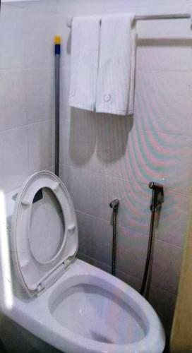 a bathroom with a toilet with the seat up at The Viana Apartment 1 in Kota Bharu