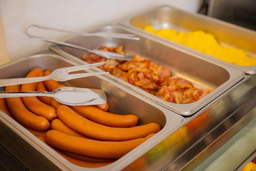 a tray of hot dogs and other food items at Bazilika alatt Panzió in Esztergom