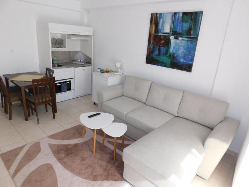 a living room with a couch and a table at Elatos Apartments in Klitoria