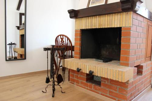 a brick fireplace with a fire place in a room at Studio apartman Kendi in Sutivan