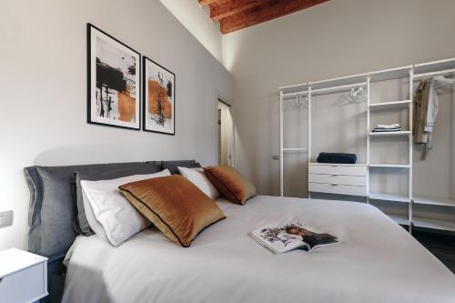 a bedroom with a bed with a book on it at La Terrazza 62 in Bergamo