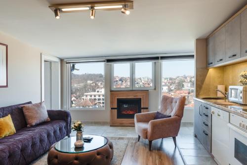 a living room with a couch and a fireplace at IN LUX APARTMAN in Vrnjačka Banja