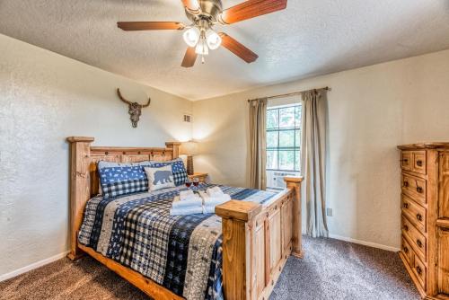 a bedroom with a bed and a ceiling fan at Four Cubs in Ruidoso
