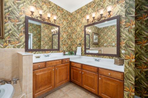 a bathroom with two sinks and a large mirror at 852 Cinnamon Beach in Palm Coast