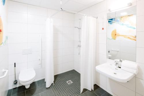 a white bathroom with a sink and a toilet at Hotel am Zoo in Neunkirchen