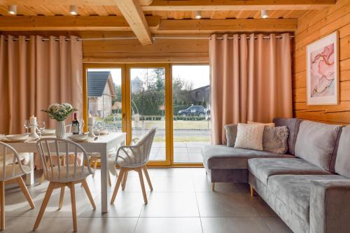a living room with a couch and a table at Bajkowe Domki in Kudowa-Zdrój