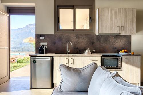 a kitchen with a sink and a dishwasher at Euphoria Suites in Avia