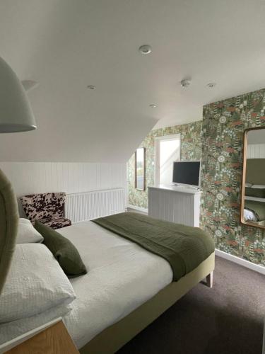 1 dormitorio con 1 cama grande y TV en Falmouth Bay en Falmouth