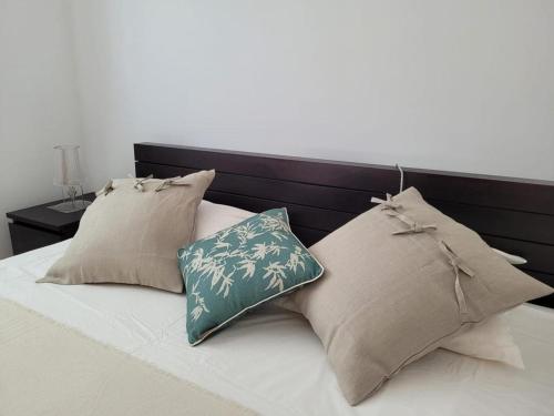 a bed with two pillows on top of it at Olive Ap. in Torreira