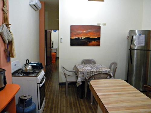 a kitchen with a table and a table and a table and a table at Casa Blanca Puerto López in Puerto López