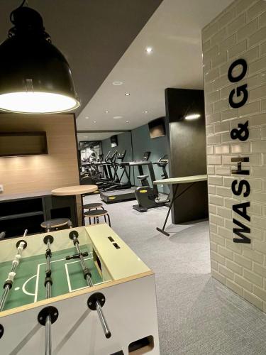 a gym with a ping pong table in a room at zeitwohnhaus SUITE-HOTEL & SERVICED APARTMENTS in Erlangen