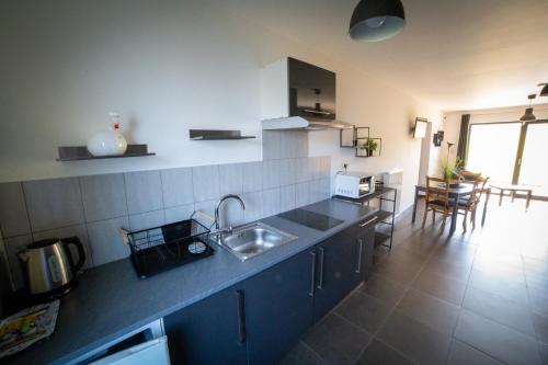 a kitchen with a sink and a counter top at La Chambre Du Pèlerin in Foy-Notre-Dame