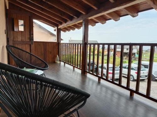 a balcony with two chairs and a view of a parking lot at Casa La Fonte in Barcia