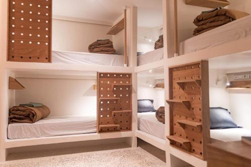 a room with four bunk beds in it at SwellHouse in Tamraght Ouzdar