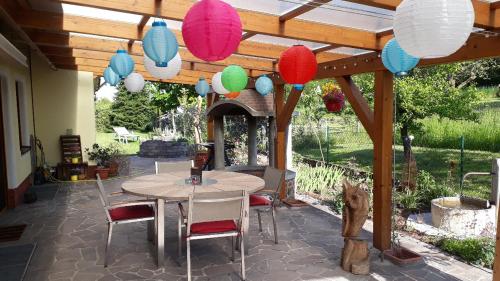 a patio with a table and chairs and lanterns at Gästezimmer in traumhafter Lage neben der Kurstadt in Oberthulba