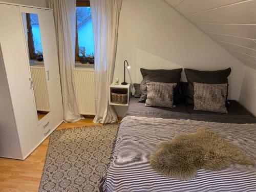 a bedroom with two beds with a furry rug on it at Gemütliches Appartement an der Riß in Biberach an der Riß
