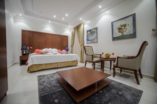 a bedroom with a bed and a table and chairs at شقق مفروشة مميزة - hotel apartments for rent in Jeddah