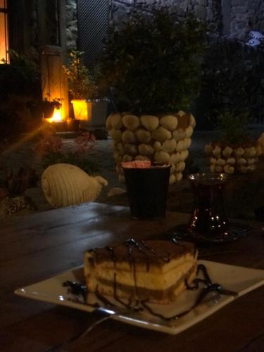 a plate with a piece of cake on a table at Harmony Butik Otel in Alanya