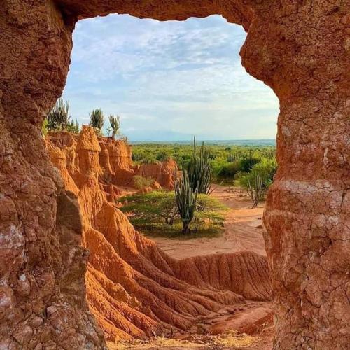 a view of the desert through a rock formation at Hostal Arámbulo in Villavieja
