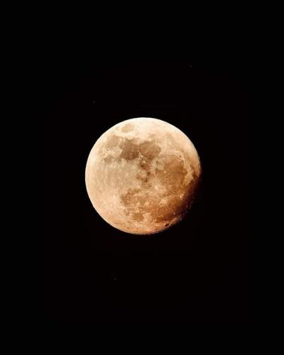 a yellow moon in the black sky at Hostal Arámbulo in Villavieja