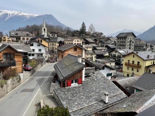 a view of a town with houses and a street at Harmony House in Salvan