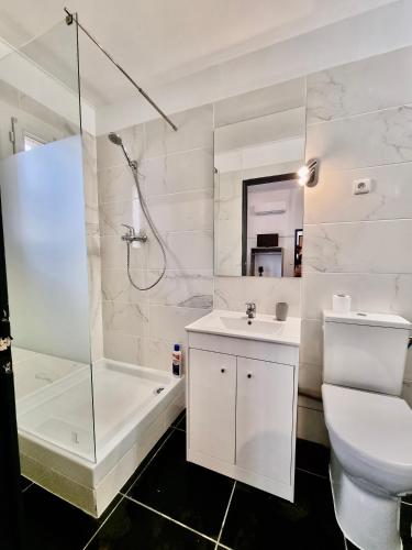 une salle de bain blanche avec une douche, des toilettes et un lavabo dans l'établissement Les Saules Studio Wifi Clim Gare Centre, à Avignon