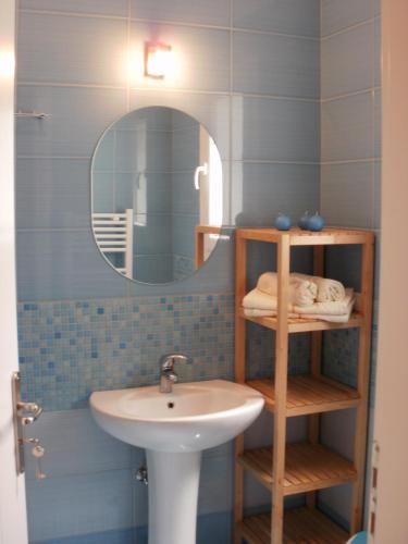 a bathroom with a sink and a mirror at Afroessa Studios & Apartments in Samos