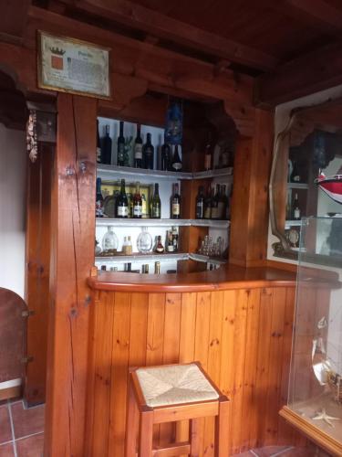 a wooden bar with a bench in a room at Il Nido dell'aquila in Sardara