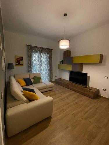 a living room with a couch and a flat screen tv at Casa Vacanze al Trenta3 in Marsala