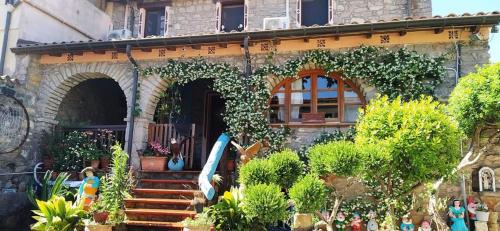 a house with stairs and plants in front of it at Il Nido dell'aquila in Sardara