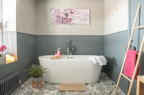 a bathroom with a white tub in a room at Luxury Cottage Nestled in the Heart of Pickering - Pet Friendly in Pickering