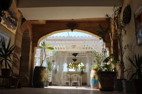 an entrance to a building with a chandelier and plants at Osiris Hotel Cairo in Cairo