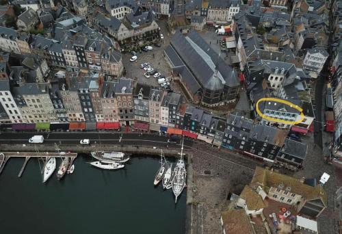 an overhead view of a city with boats in the water at La Loge des Artistes in Honfleur