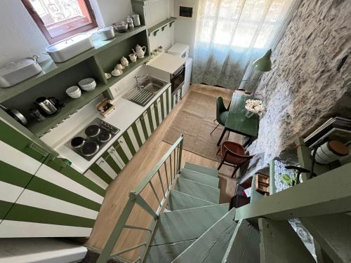 a staircase leading up to a kitchen and a living room at Castagna Holiday Home in Nesso