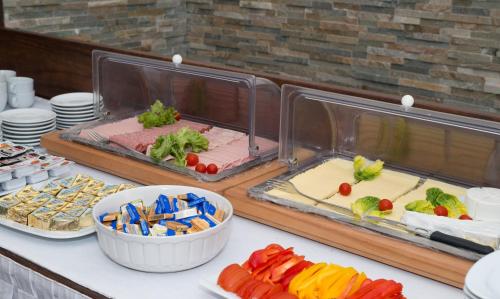 a buffet with different types of food on a table at Hotel Marc Aurel - Vienna City Center in Vienna