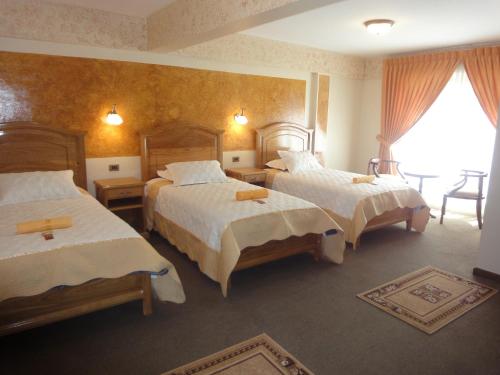 En eller flere senger på et rom på HOTEL MAISON FIORI (Plaza Colon)