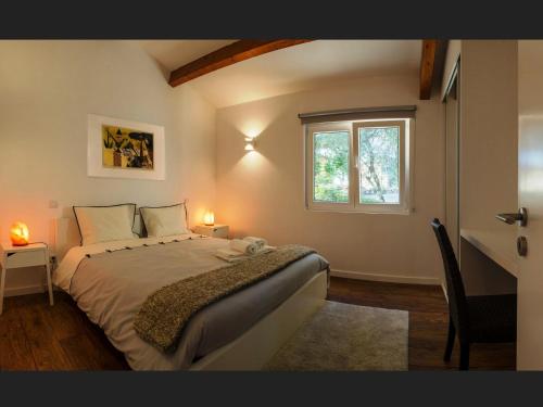 a bedroom with a large bed and a window at Quinta da Teimosa in Monção