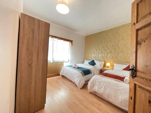 a bedroom with two beds and a window at Park Terrace Professional Let in Bedlington