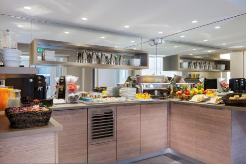 a kitchen with alot of food on the counter at Timhotel Opéra Blanche Fontaine in Paris