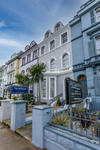 a large white building with a sign in front of it at The Belmont in Torquay