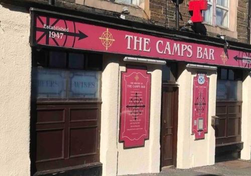 a building with a pink sign for the cannes bar at Harbour bridge, Camps bar in Wick
