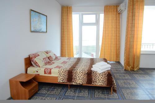 a bedroom with a bed and a window at Mini-hotel Tikhaya Gavan in Kyrylivka