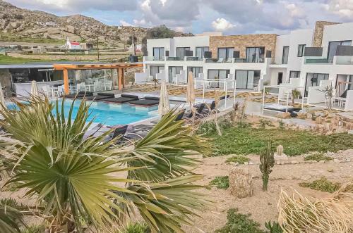 a resort with a swimming pool and a building at Bianco a Nero Mykonos in Mýkonos City