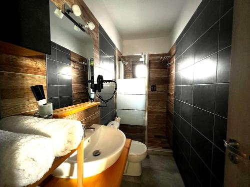 a bathroom with a sink and a toilet at Villa Athina 1st floor in Nea Kallikrateia