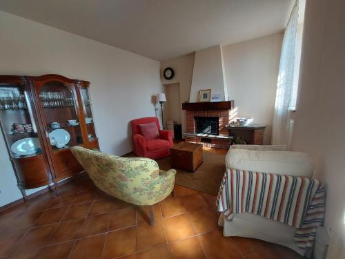 a living room with two chairs and a fireplace at Mulino di Limido in Zerbolò