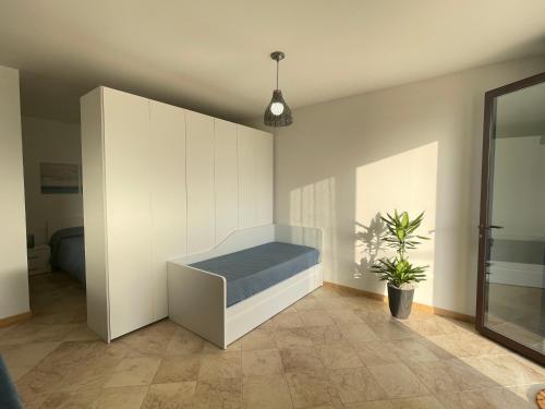 a bedroom with a bed and a potted plant at GIOIA'S HOUSE in Custonaci