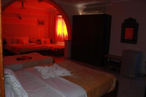 a hotel room with two beds and a red light at Osiris Hotel Cairo in Cairo