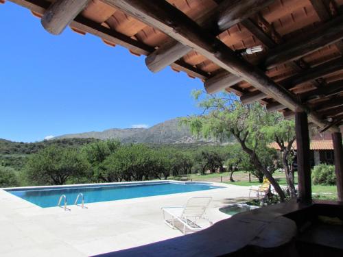 a swimming pool with a view of a mountain at Cabañas San Miguel in Cortaderas